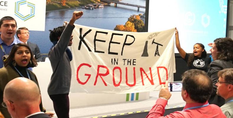 Protesters at the U.S.-hosted event at the UN climate talks in Katowice, Poland.  Photo: AP