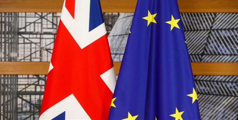 The Union Jack (L), the national flag of the United Kingdom, and the flag of the European Union are pictured within a bilateral meeting of Britain's prime mini