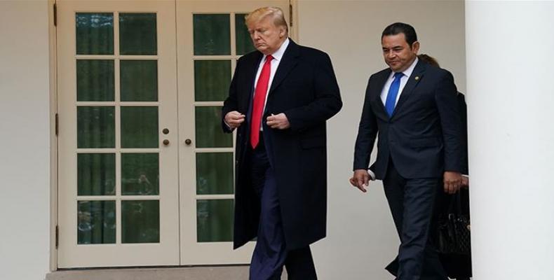 Trump walks with Morales after the Guatemalan president's arrival at the White House.  (Photo: Kevin Lamarque/Reuters)