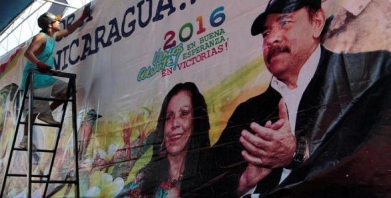 A man hoists a banner in support of Nicaragua's President Daniel Ortega.  Photo: Reuters