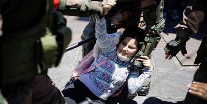 A woman is detained by military police members in Valparaiso, Chile.  (Photo: Reuters)
