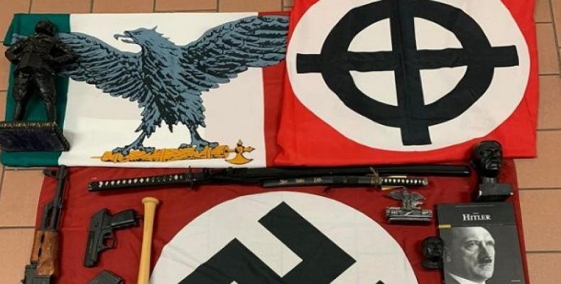 Weapons and a Nazi flag with a swastika seized by Italian authorities.  (Photo: Reuters)
