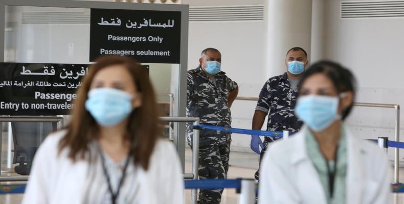 Health workers and members of internal security forces wearing face masks at Beirut international airport.  (Photo: Aziz Taher/Reuters)