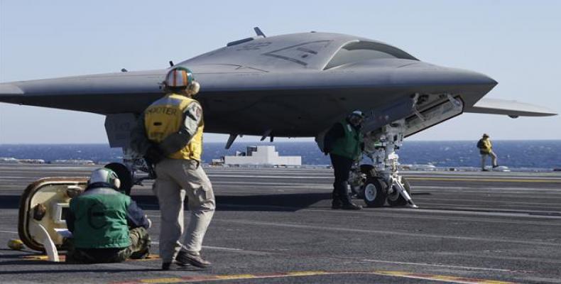 The flightdeck crew preparing to launch the X 47B, an experimental Unmanned Drone Aircraft.  Photo: US military file photo