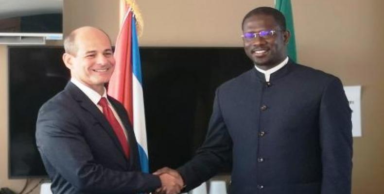Rogelio Sierra (left) greets Moise Diardiégane Sarr, Secretary of State at the Ministry of Foreign Affairs and Senegalese Abroad,