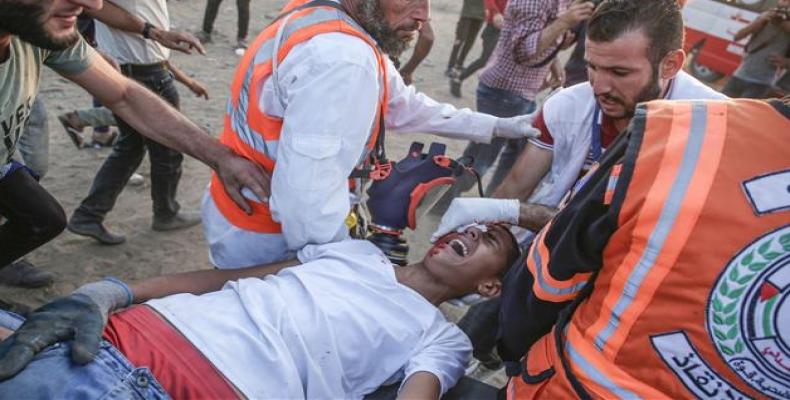 Palestinian protester treated after being wounded by Israeli troops.  (Photo: AFP)