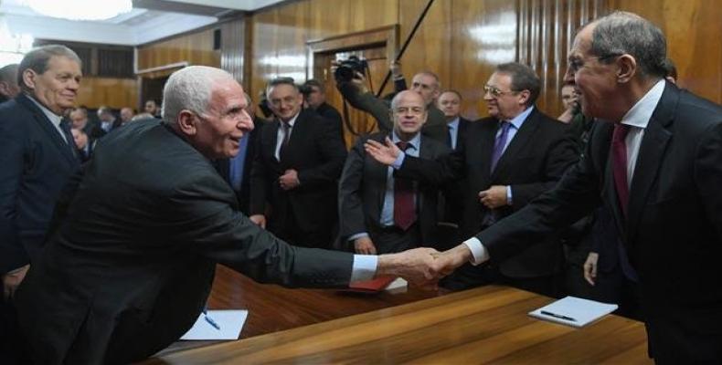 Russian Foreign Minister Sergei Lavrov shakes hands with Fatah official Azzam al-Ahmad during a meeting with representatives of Palestinian groups and movements