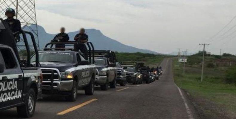 The Michoacan state police force ride in to arrest all 28 members of the Ocampo municipal police force.   Photo: @MICHOACANSSP