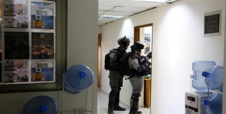 Israeli soldiers storm the offices of the official Palestinian news agency in the occupied West Bank city of Ramallah on December 10, 2018.  Photo: Ma'an News A
