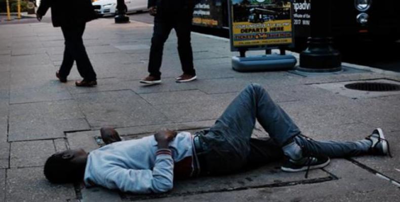 A homeless man sleeps on a sidewalk in Philadelphia, Pennsylvania.  (Photo: AFP)