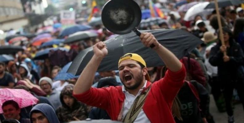 A man bangs a pan during a protest march in Bogota, Colombia.  (Photo: Reuters)