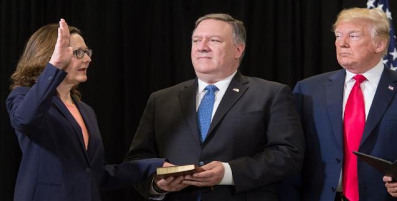 Gina Haspel (L) is sworn in as the Director of the Central Intelligence Agency alongside US President Donald Trump (R) and US Secretary of State Mike Pompeo (C