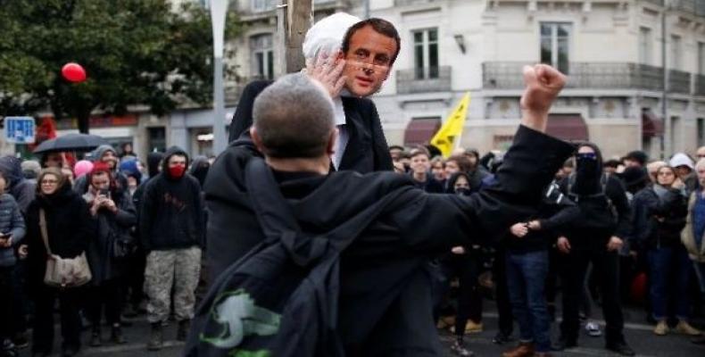 A protester punches a dummy depicting French President Emmanuel Macron in Nantes, France.  Photo: Reuters