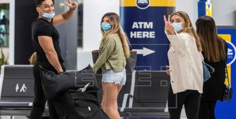 Viajeros ataviados con mascarillas a su llegada al Aeropuerto de Palma de Mallorca, este domingo, durante el primer día del fin del estado de alarma, en el que