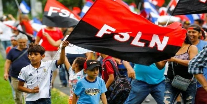 People hold Sandinista National Liberation Front flags on the 39th anniversary of the Nicaraguan Revolution.  Photo: Reuters
