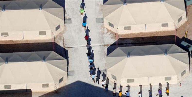 Migrants imprisoned in tent camp.  Photo: AP