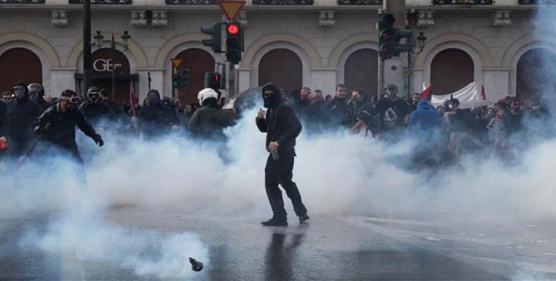 Greek university students are seen amid tear gas as they clash with riot police in Athens.  (Photo: Reuters) 