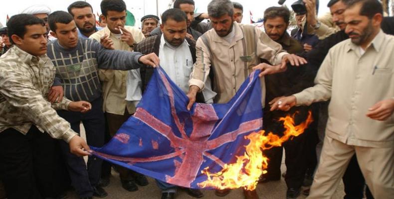 Iraqis burn UK flag in Basra after news of British military abuse of Iraqi boys.  (Photo: Nabil Al-Jurani/AP)