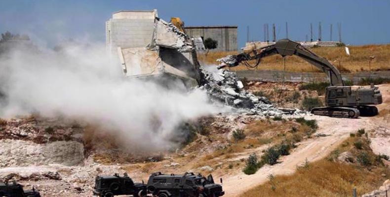 Israeli forces tear down a Palestinian building under construction in the West Bank village of Dar Salah, which straddles the West Bank and Jerusalem. (Photo: A
