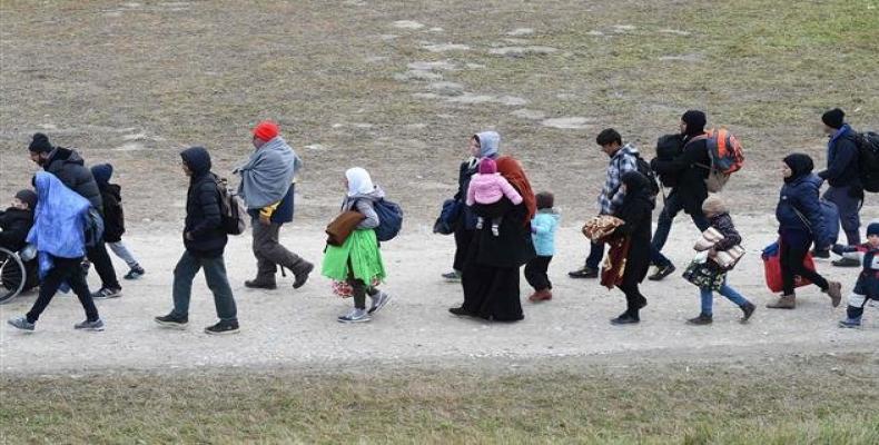 File photo taken on October 27, 2015 migrants walk to the first registration point of the German federal police after they passed the Austrian-German border bri