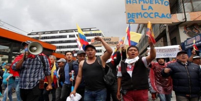 Demonstrators hold up a sign, which reads ''Democracy has died,&quot; during a protest against Ecuador's President Lenin Moreno's government in Quito, Ecuador.