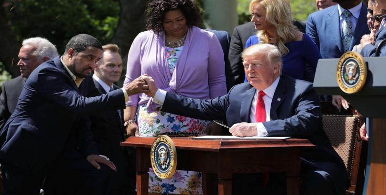 Trump with Pastor Darrell Scott.  A group run by Scott gave away $25,000 in cash-stuffed envelopes at events promoting Trump