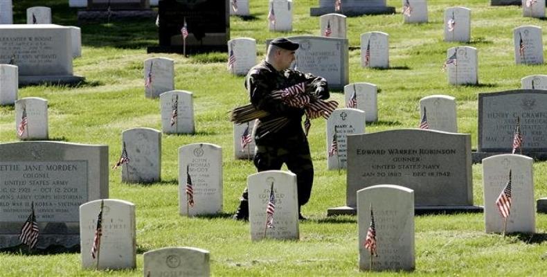 In this AFP file photo taken on May 26, 2005, a member of the 3rd US Army Infantry places flags on the graves of veterans at Arlington National Cemetery in Arli
