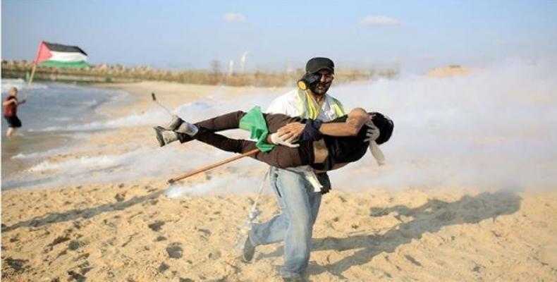 A Palestinian protester is injured in the northern part of the besieged Gaza Strip during a naval rally against the decade-long Israeli siege on the impoverish